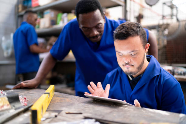 Colleagues using digital tablet and working in industry